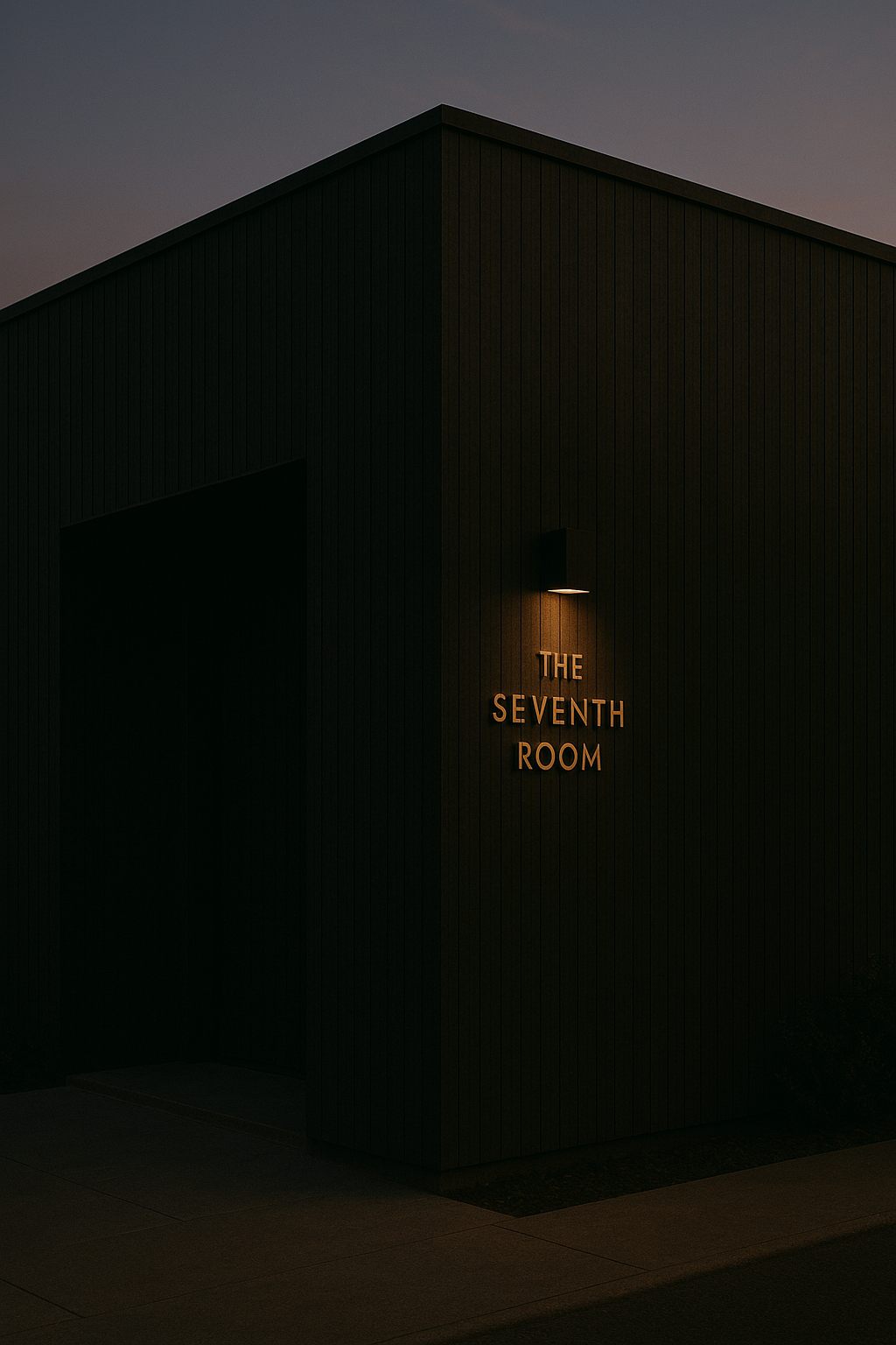 Warm, minimal building exterior at dusk